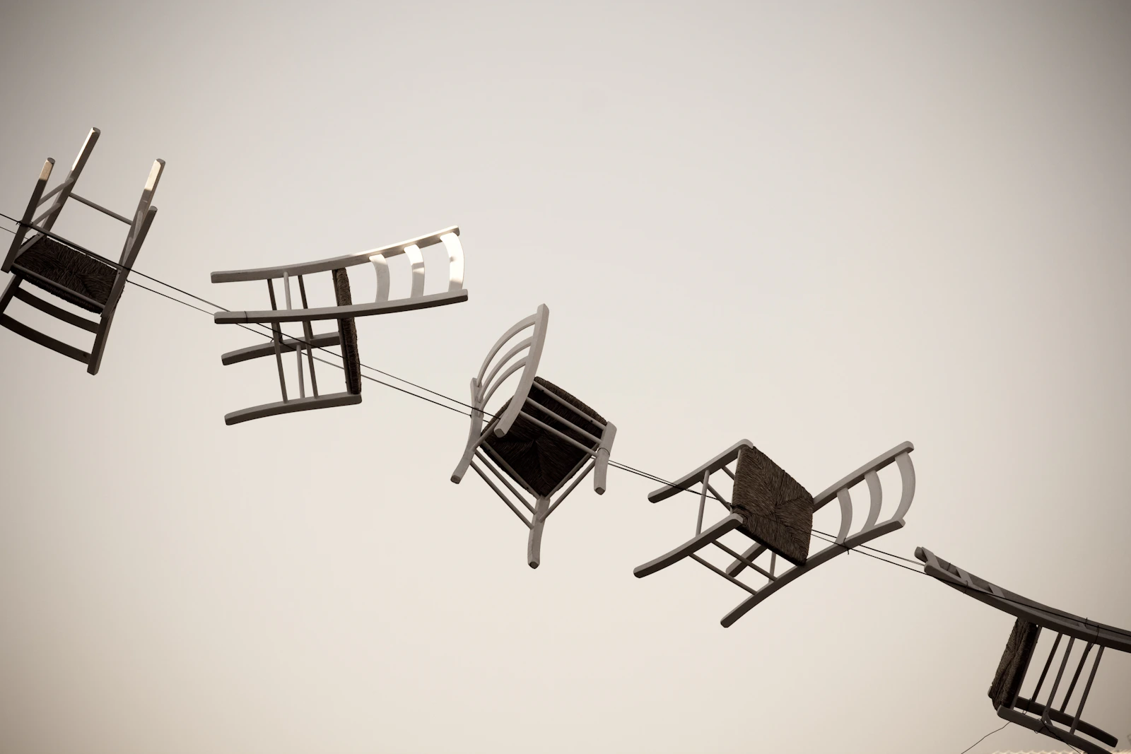 Empty chairs arranged in a circle, evoking musical chairs and mismatched seats