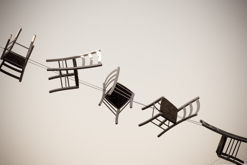 five brown wooden chairs