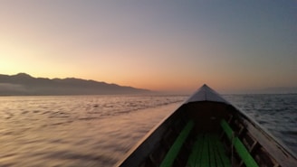 A tranquil scene of a boat ride on the Ganges during sunset.