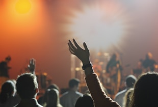 shallow focus photography of hand and people