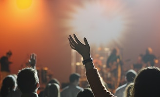 shallow focus photography of hand and people