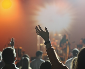 shallow focus photography of hand and people