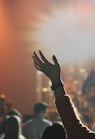 shallow focus photography of hand and people