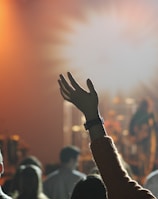 shallow focus photography of hand and people