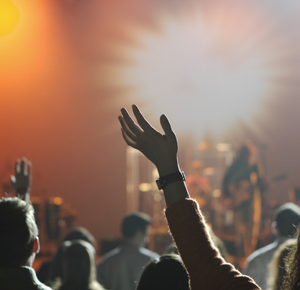 shallow focus photography of hand and people