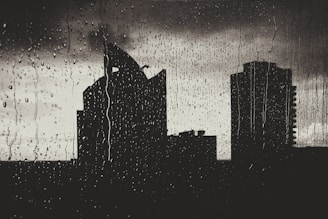 Still frame of a dark cityscape with neon reflections and animated rain.