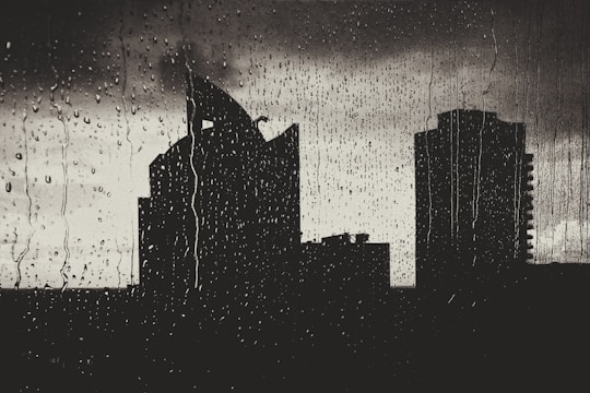 Still frame of a dark cityscape with neon reflections and animated rain.