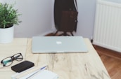 A calm desk setup featuring a laptop and stationery.