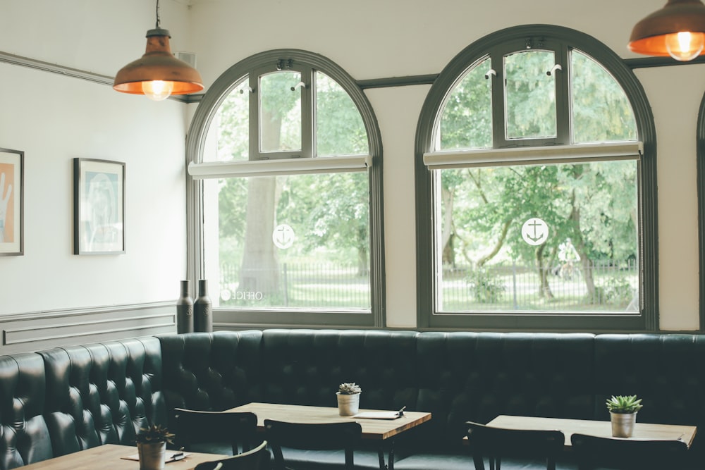 brown wooden table near window