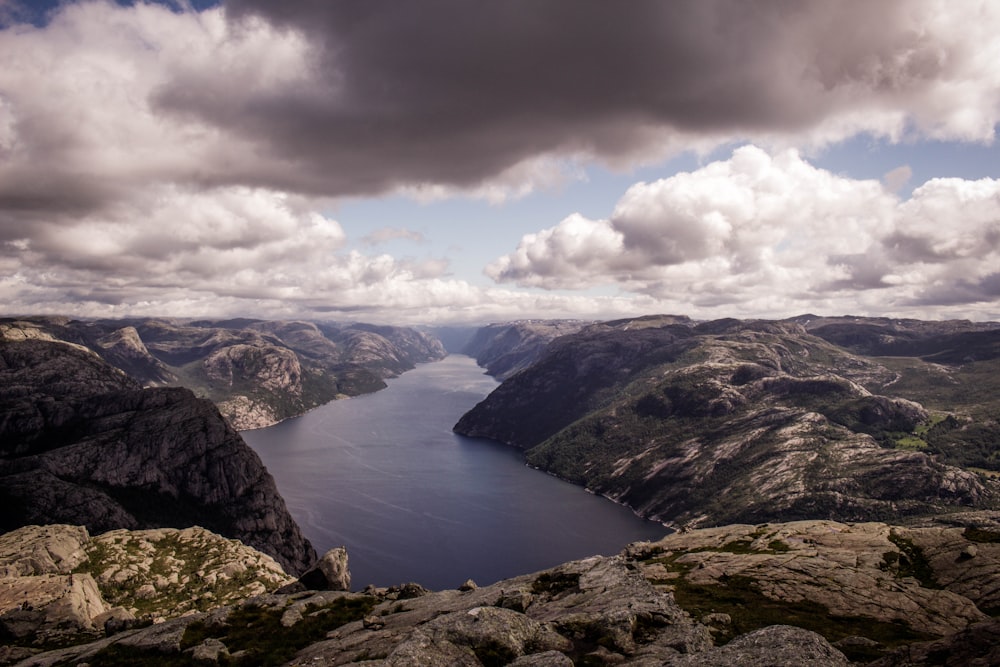 landscape photography of mountains and body of water during daytime