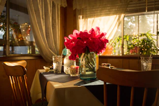 A cozy dining table set with a soft linen tablecloth and fresh flowers, inviting conversation.
