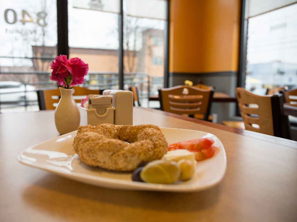 doughnut on white ceramic saucer on table