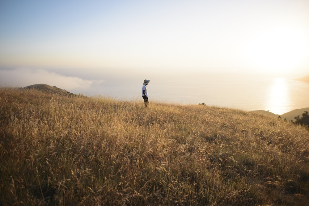 man standing on brown field during daytime