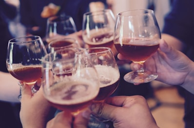 people holding snifter glasses