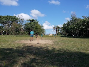 Children playing cricket in a local field in Chhita Pandariya.