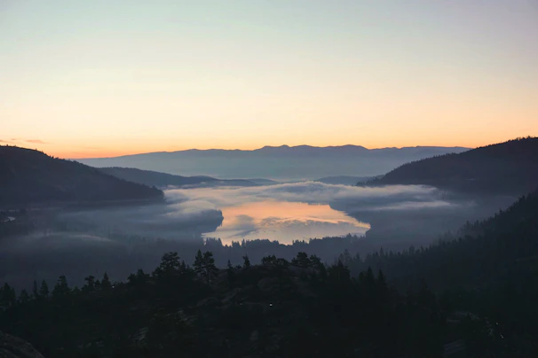A serene landscape video still of a misty mountain at sunrise.