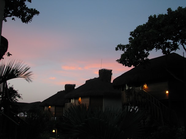 Evening view of the homestay illuminated softly against a twilight sky.