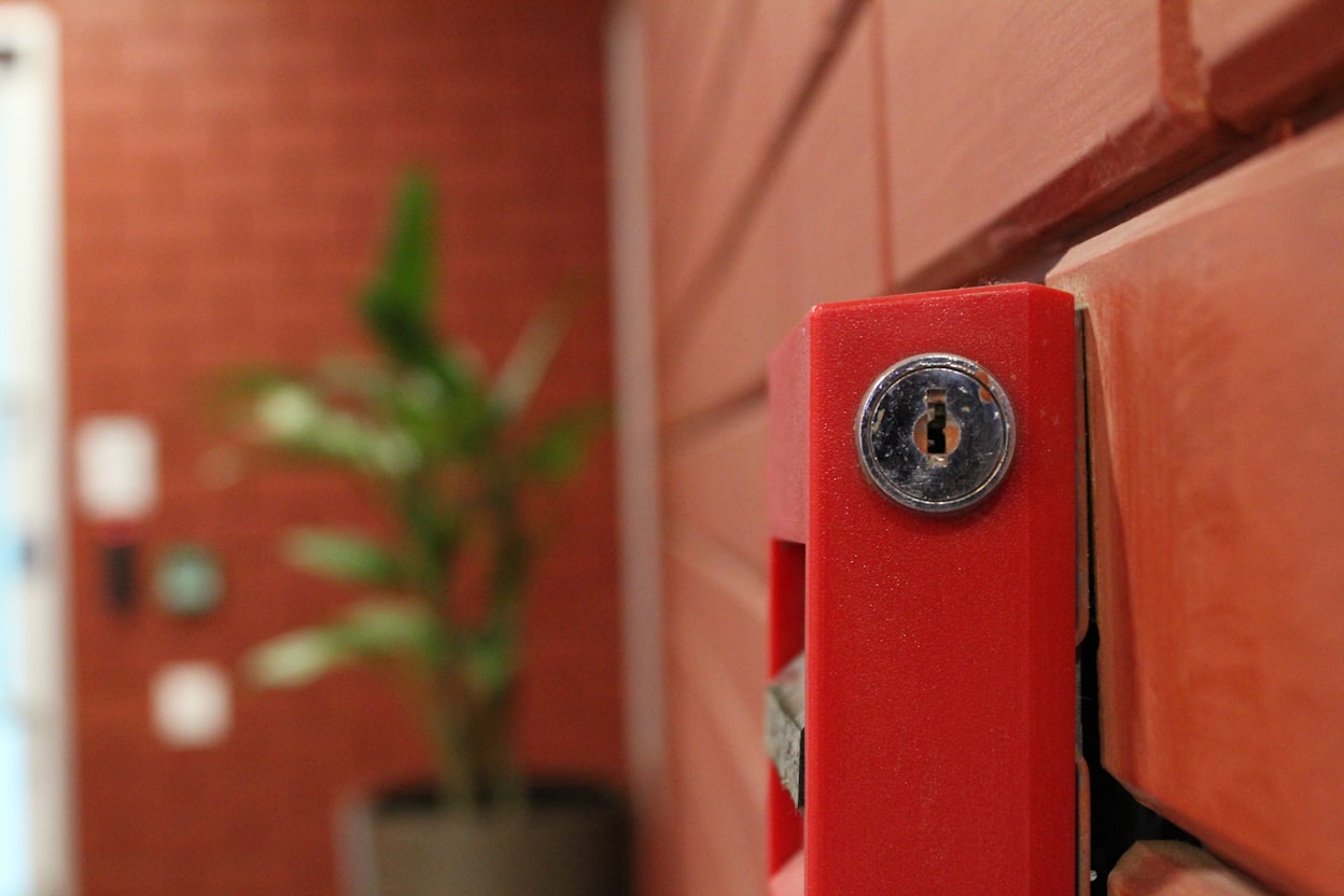 Addressable fire alarm control panel with zone indicator LEDs inside a Malaysian commercial building plant room