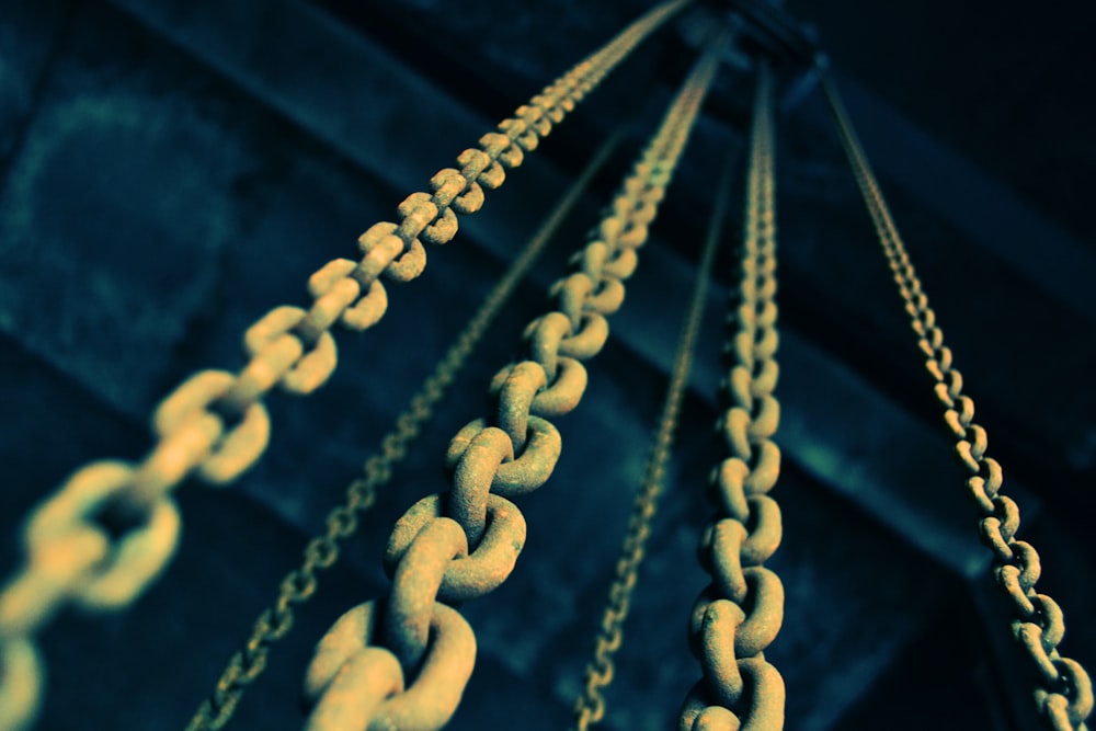 low angle photography of gray metal chains