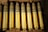 Rows of various munitions neatly organized on metal shelves in a warehouse.