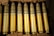 Rows of various munitions neatly organized on metal shelves in a warehouse.