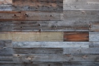 Rustic reclaimed wood cladding with varied tones creating a textured wall.
