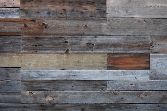 A rustic wooden panel wall with natural pine lambris highlighting texture and warmth.