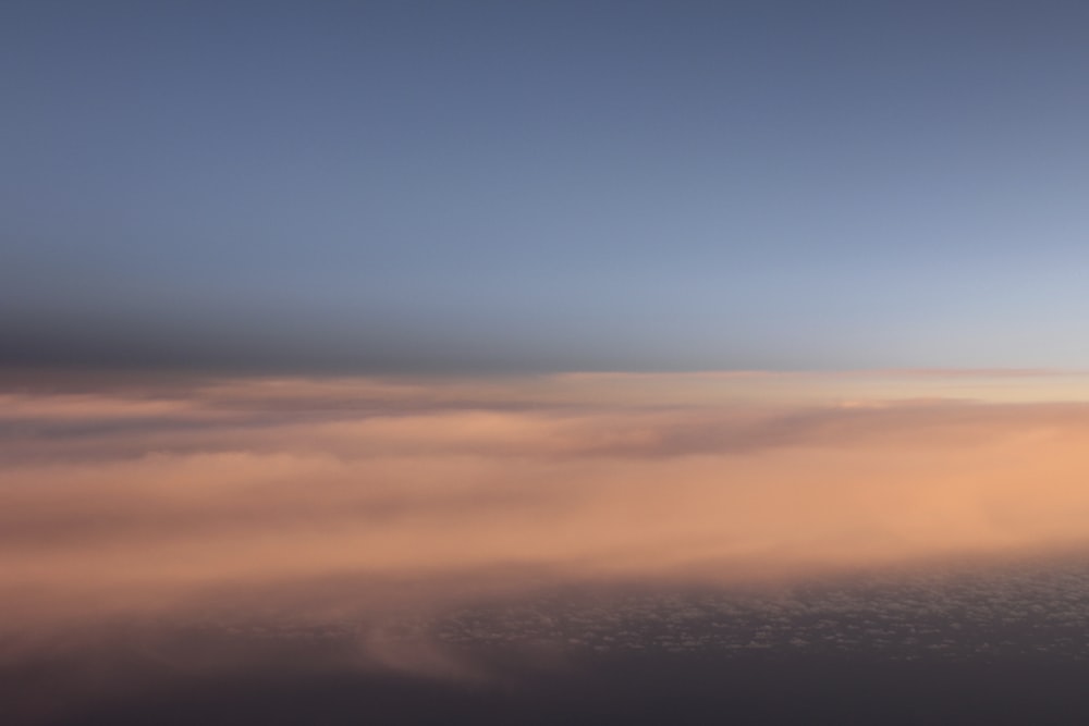 a plane flying in the sky above the clouds