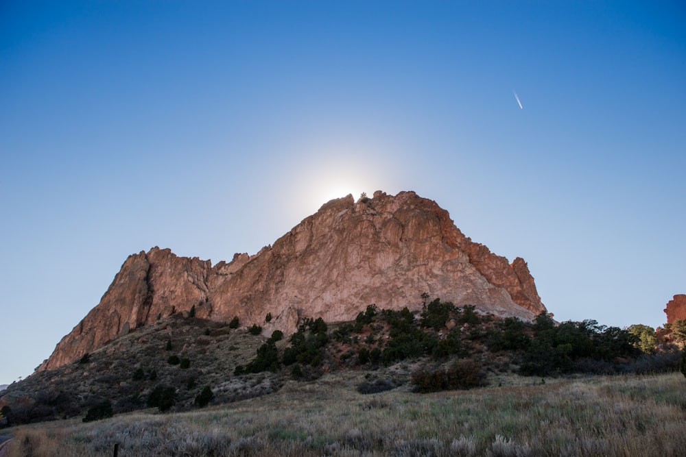 montanha marrom perto de árvores fotografia de ângulo baixo