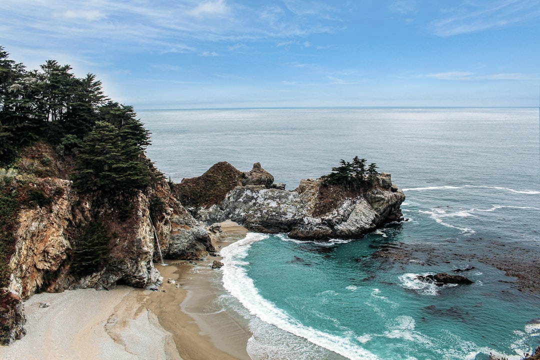 high-angle photo of green sea near white sand beach