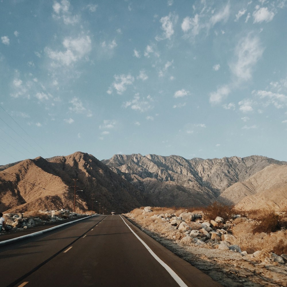 brown top road and rock mountain during day time