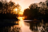A serene sunset over the Douro River, with soft golden light reflecting on the water.