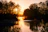 A serene sunset over the Nile with soft golden light reflecting on ancient temple ruins.