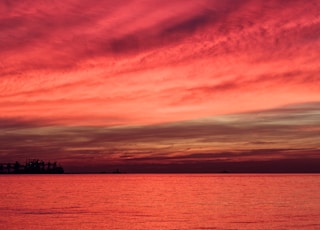 silhouette of structure under red sky