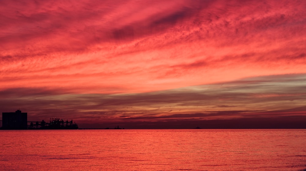 silhouette of structure under red sky