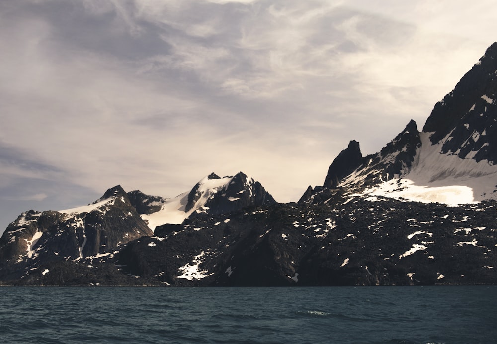 mountain alps near body of water