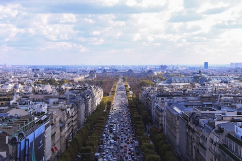aerial photo of city under white clouds