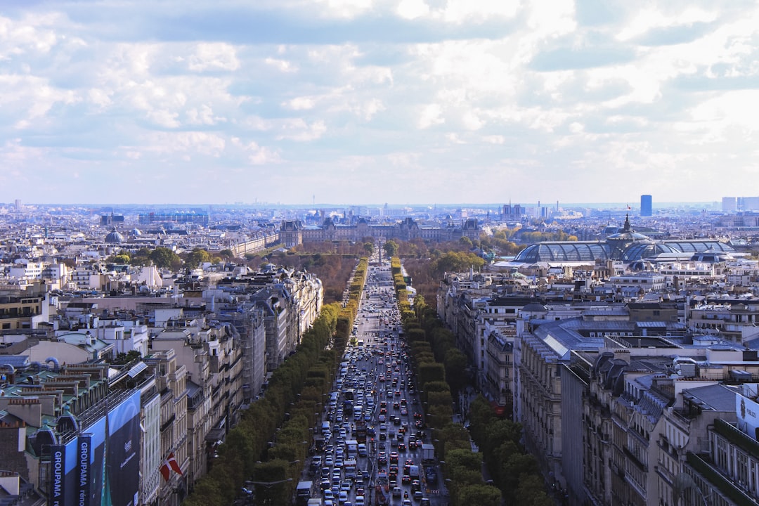 aerial photo of city under white clouds, Cityscape of Paris with traffic