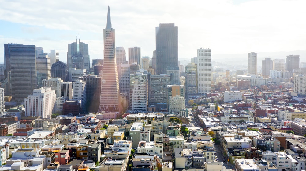 aerial photography of concrete buildings under blue cloudy sky