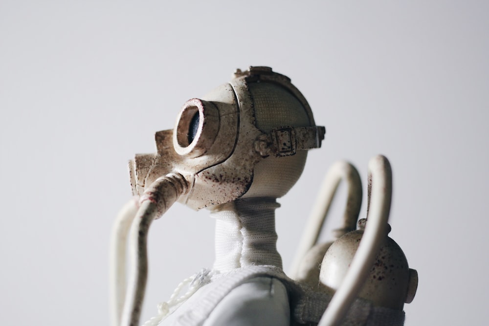 selective focus photography of man wearing gas mask and oxygen tank