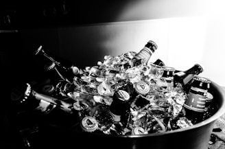 Chilled beer cans and bottles with condensation, set against a rustic background.