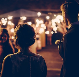 man standing near the woman walking in party during nighttime