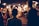 man standing near the woman walking in party during nighttime