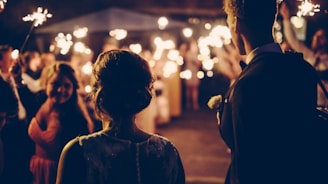 man standing near the woman walking in party during nighttime