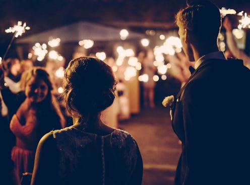 man standing near the woman walking in party during nighttime