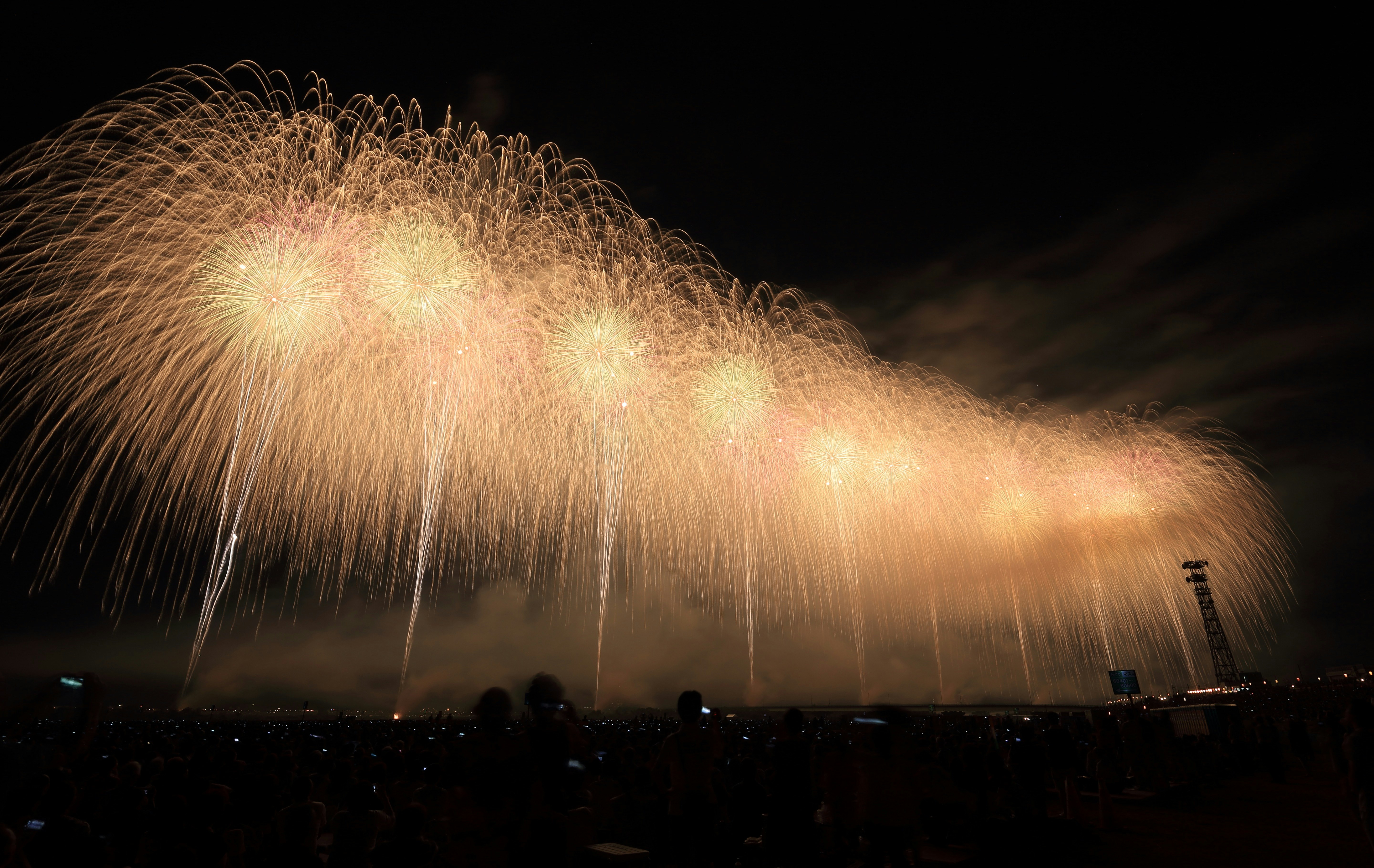 yellow fireworks above a city during night time