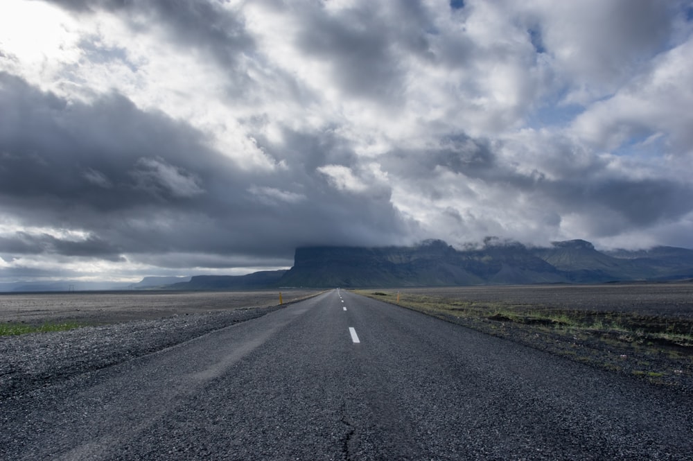 concrete road under cumulunimbus clouds