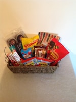 A wooden crate overflowing with wrapped chocolates and toffees
