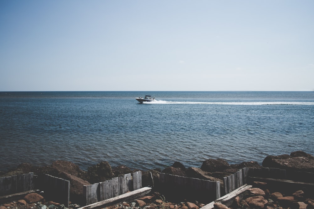 speedboat on body of water during day time