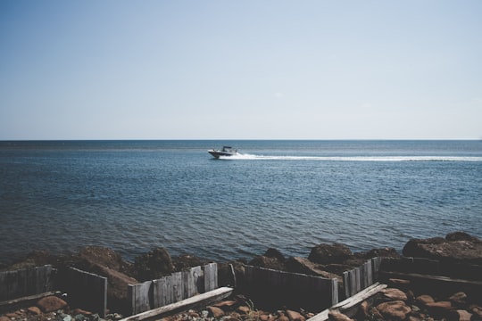 speedboat on body of water during day time in North Rustico Canada